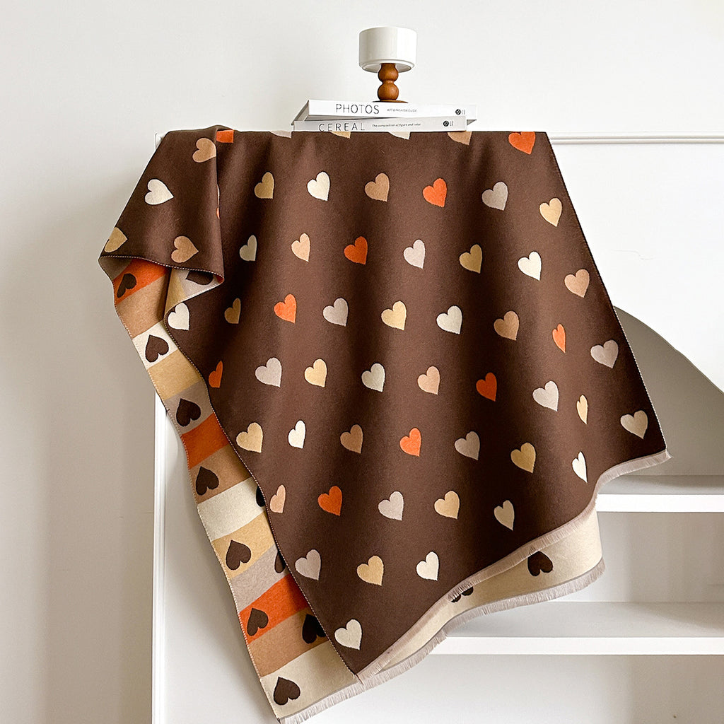 Brown fabric with heart pattern draped over a white surface