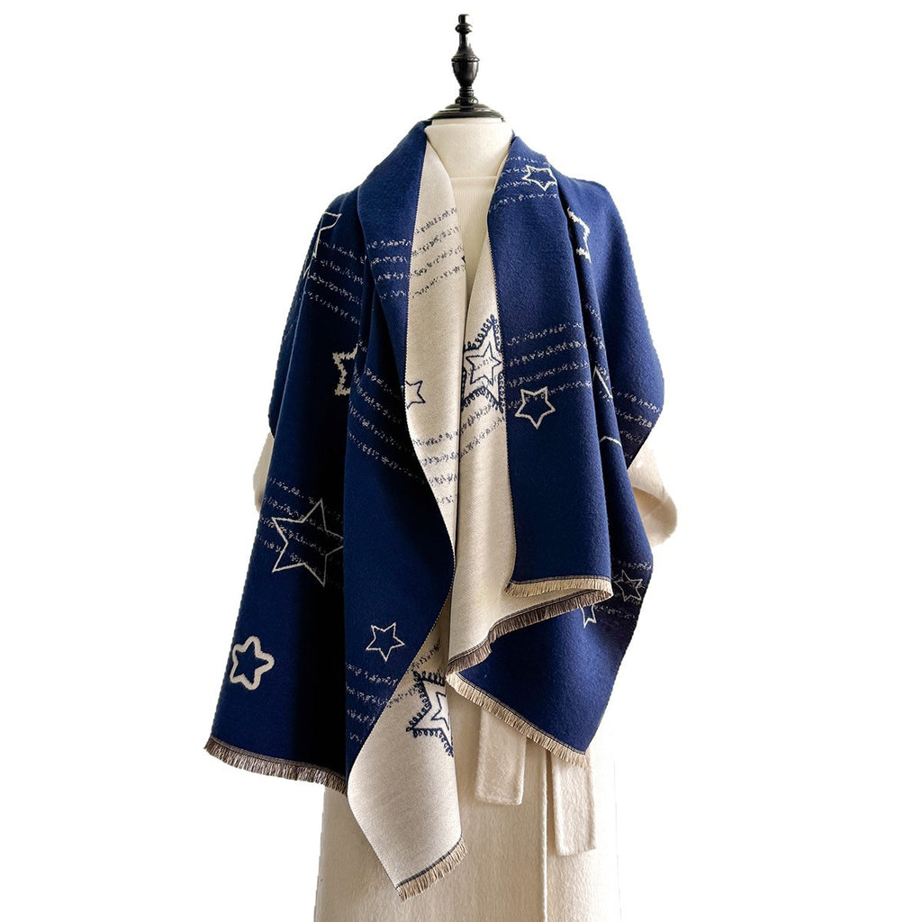 A navy blue and cream shawl with embroidered star patterns and script text, draped on a cream-colored mannequin torso against a white background.